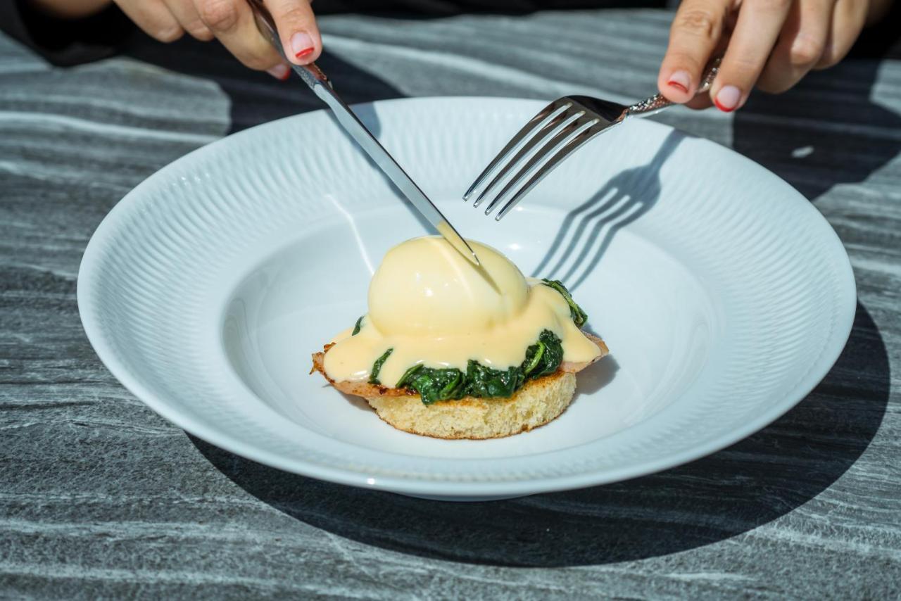 El Llorenc Parc De La Mar - Adults Only Palma de Mallorca Exterior photo A poached egg being cut with a knife and fork